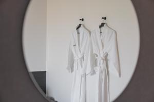 テジョンにあるWorkers Hotel Daejeon by Aankの鏡に映る白い二着の映り