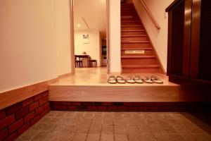 a staircase in a building with a room with a table at Osaka Umeda Yuan Hostel in Osaka