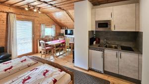 a kitchen and living room in a log cabin at Hochfelner-Prutti - Stockerhof in Sankt Marein bei Knittelfeld