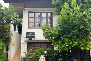 a building with a sign in front of a garage at Suite by the Sea Apartment Seminyak in Seminyak