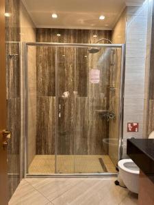 布哈拉的住宿－Hotel Bukhara，浴室里设有玻璃门淋浴