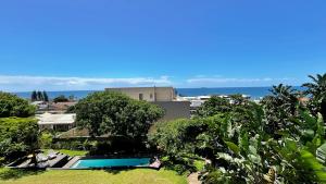an aerial view of a resort with a swimming pool and trees at B'Lenghi Beach House in Ballito