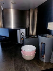 a kitchen with a mixing bowl and a microwave at Appart'Chic in Paris