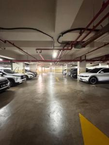 a parking garage filled with lots of parked cars at Pejaten Park Residence in Jakarta
