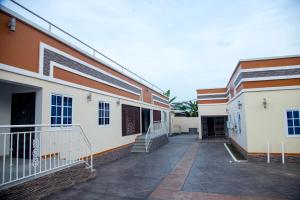 a building with a walkway between two buildings at BryMac Hotel in Koforidua