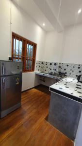 a kitchen with a stove and a counter top at Margaret House in Mirissa