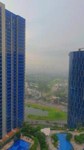 an aerial view of a city with two tall buildings at Apartement orchard Surabaya in Surabaya +1 photo
