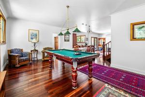 a living room with a pool table in it at Blokhus, a stunning retreat in the treetops in Bandon Grove