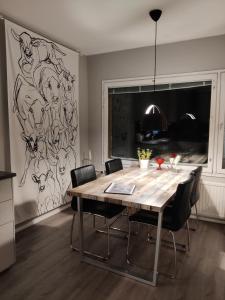 a dining room with a wooden table and chairs at Freshly renovated apartment, perfect for couple in Kerava