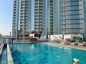 a large swimming pool on top of a building at Stylish brand new 1 bedroom in Dubai