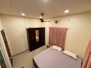 a small bedroom with a bed and a dresser at sacred river homestay in Alleppey