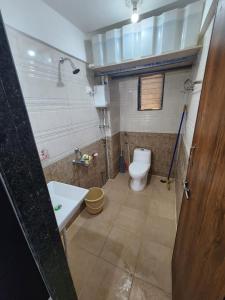 a bathroom with a toilet and a sink at Ocean Front By Seascapes in Ānjarle