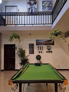 a green pool table in a room with a staircase at WAKE UP @Lanta Hotel : Cafe in Ko Lanta