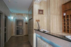 a hallway of a building with a counter and a door at Maximo Hotel in Tivoli Terme +23 photos
