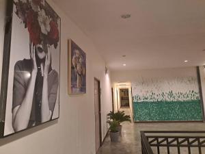 a hallway with two pictures of a woman on the wall at WAKE UP @Lanta Hotel : Cafe in Ko Lanta