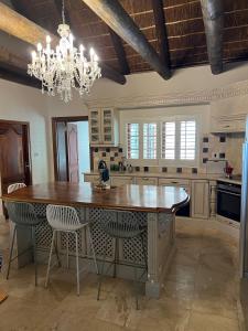 a large kitchen with a large wooden table and chairs at Kleinhof in Franschhoek