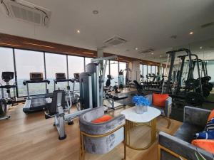 a gym with treadmills and exercise equipment in a building at The AstraSkyRiver Luxurious 2 Full Bedroom Condo - 73 SQM in Chiang Mai