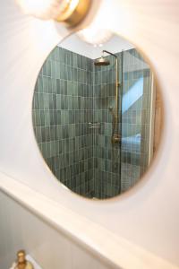 a bathroom mirror with a shower in a bathroom at Loo kodu&köök in Muraste