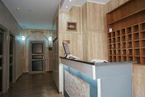 a bar in a room with a hallway with a door at Maximo Hotel in Tivoli Terme