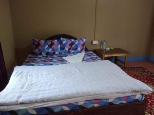 um quarto com uma cama grande e uma mesa em Hotel Tree Land em Sauraha