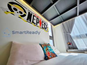 a bedroom with a bed with a superhero sign on the wall at Sunway GRID by SR Home in Kampong Pendas