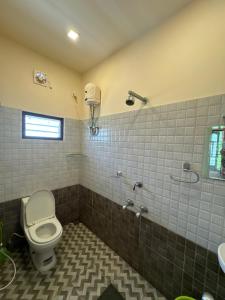 a bathroom with a toilet and a sink at sacred river homestay in Alleppey