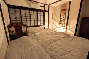 Een bed of bedden in een kamer bij 万博会場まで直通2駅10分USJ海遊館近い 朝潮橋駅徒歩4分無料駐車場有り最大12名宿泊可能 Wifi ベビー用品充実