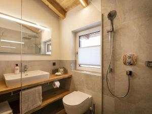 a bathroom with a shower and a toilet and a sink at Ferienwohnung HOAMAT in Going