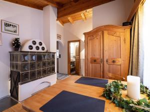 a living room with a stove and a room with mats at Ferienwohnung HOAMAT in Going