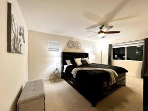 a bedroom with a black bed and a ceiling fan at EV4 DREAMZ VILLA Spacious and cozy in Everett