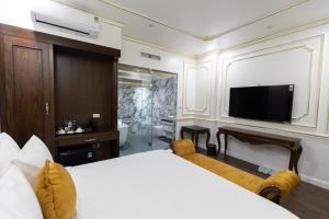a bedroom with a large bed and a television at Royal Dương Nội Hotel in Hanoi