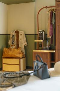 a room with a closet with a purse and clothes at voco Paris - Porte de Clichy, an IHG Hotel in Clichy