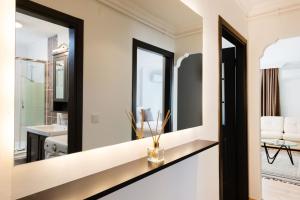 a bathroom with a mirror and a sink at G&B MANSION in Istanbul