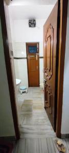 a hallway of a room with a door and a floor at Sweet Home,Stay with Maneesha&Ajay 3Rooms Kitchen in Lucknow