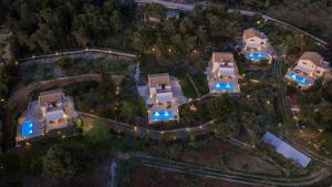 an overhead view of a house at night with lights at Villa Boscheto Tria in Agios Leon
