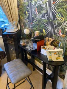 a black desk with a chair in front of a wall at The Cherry Tree Guest House in Eastbourne