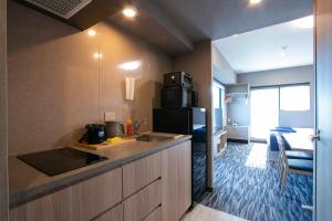 a kitchen with a sink and a refrigerator at Minn Akihabara in Tokyo