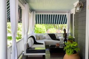 a porch with a white couch and a window at Lindenwood Inn in Southwest Harbor