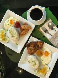 dos platos de huevos y carne y una taza de café en Containers by Eco Hotel en Tagaytay