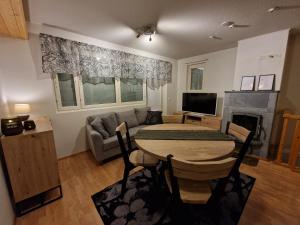 a living room with a table and a couch at Levi -Sky Slope Apartment - 3 Bedrooms in Sirkka