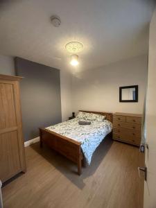 a bedroom with a bed and a dresser at M&B Accommodation in Lincoln