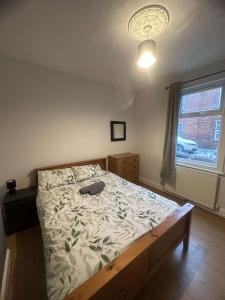 a bedroom with a large bed with a wooden frame at M&B Accommodation in Lincoln