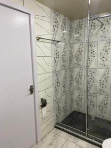 a shower with a glass door in a bathroom at Garage Hotel - Old Tbilisi in Tbilisi City