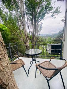 a patio with a table and chairs and a tree at Garage Hotel - Old Tbilisi in Tbilisi City