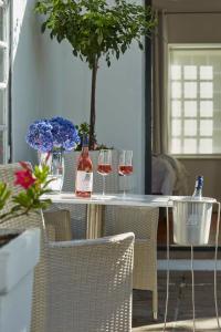 a table with two glasses of wine on it at Allèe Bleue Wine Estate in Simondium