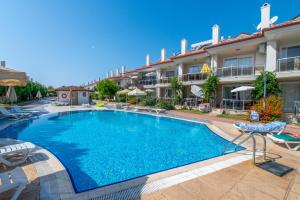 a large swimming pool in front of a hotel at Sunset Beach Resort Aqua Lettings in Fethiye