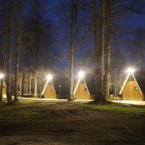 a row of wooden lodges at night with lights at ARSLANLAR İTENİÇİ BUNGALOW 