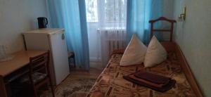 a bedroom with a bed with pillows and a window at Санаторій Збруч in Satanov