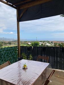 una mesa con un bol de fruta encima en Tiny house bois cosy « Halte là » en La Possession