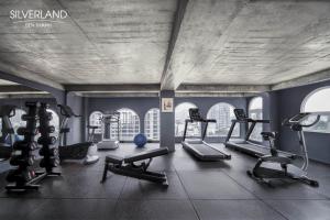 a gym with several treadmills and cardio machines at Silverland Bến Thành in Ho Chi Minh City